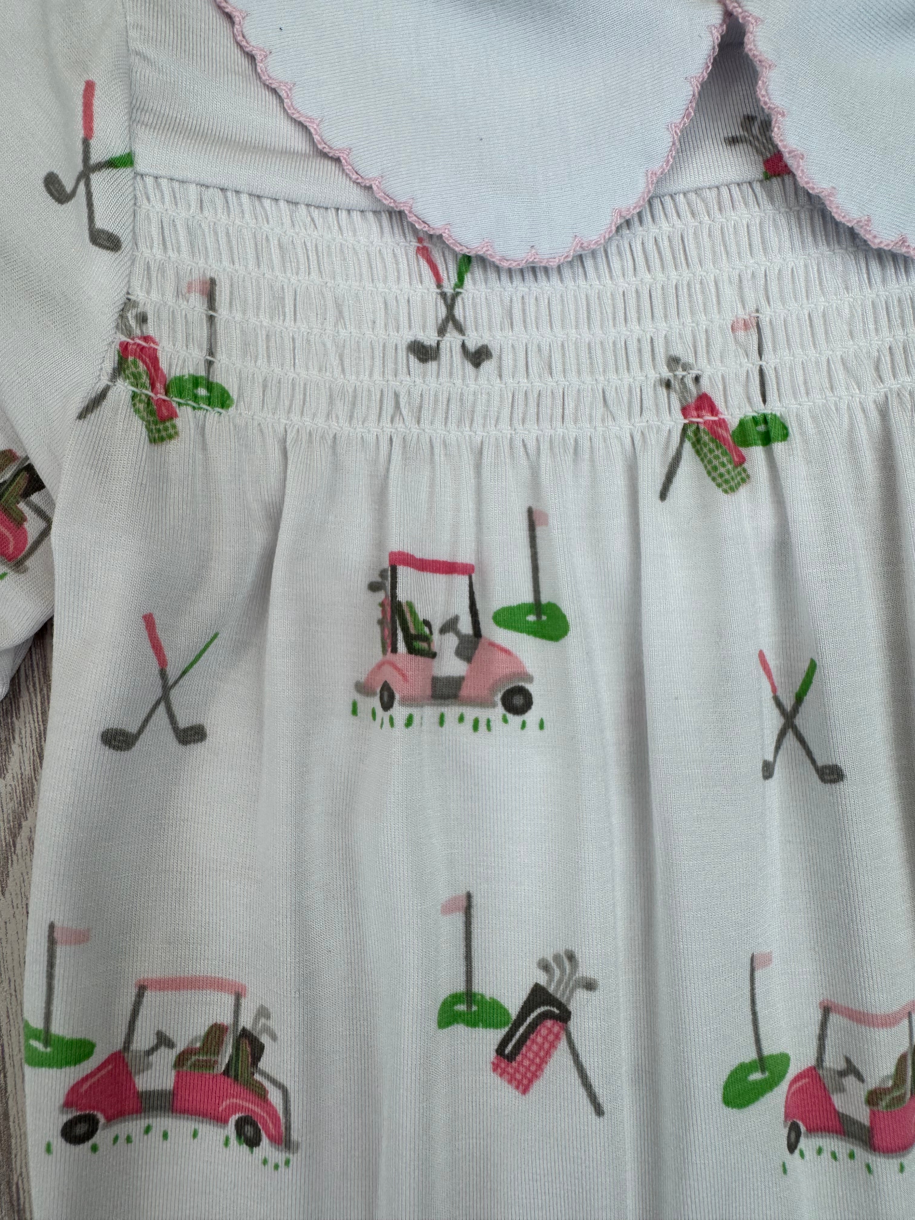 White dress with colorful golf-themed embroidery on a white background