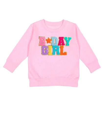 pink sweatshirt with BDAY GIRL in patches on it