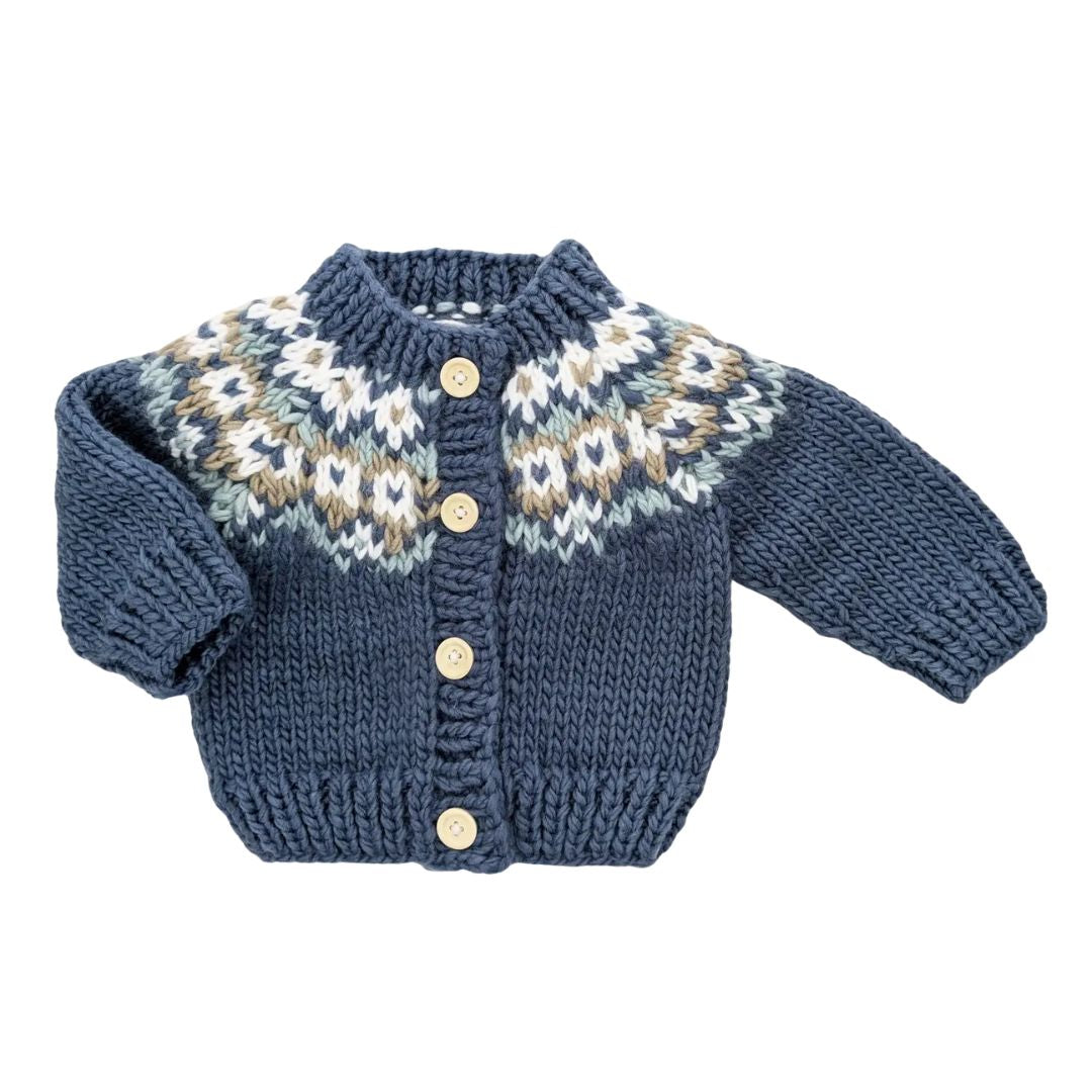 Blue knitted cardigan with fairisle patterns on a white background
