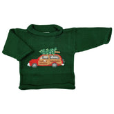 A green cotton sweater with a red wagon and Christmas tree design on the front.