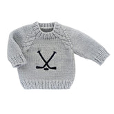 Gray knitted sweater with black hockey design on a white background