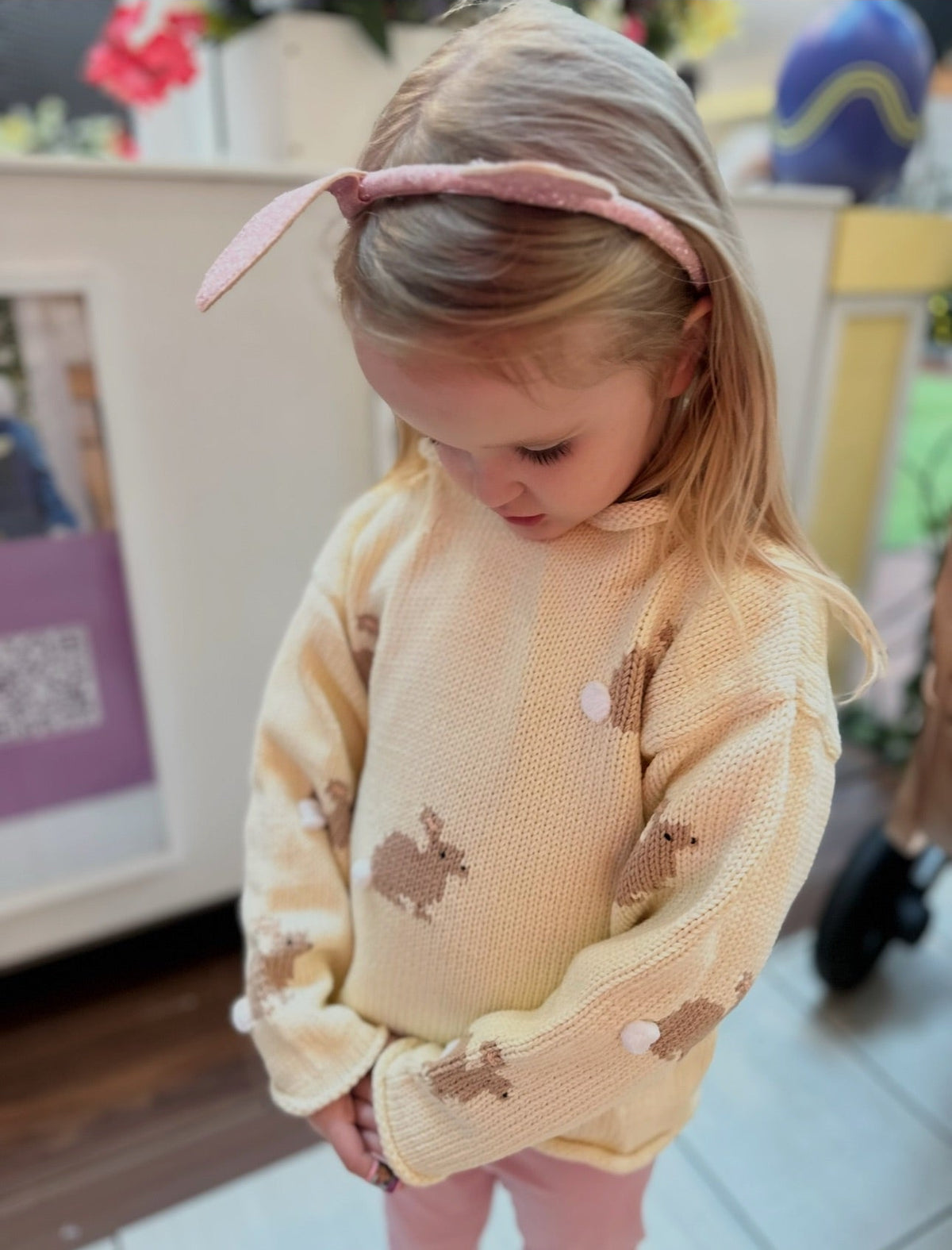girl wearing ivory bunny sweater