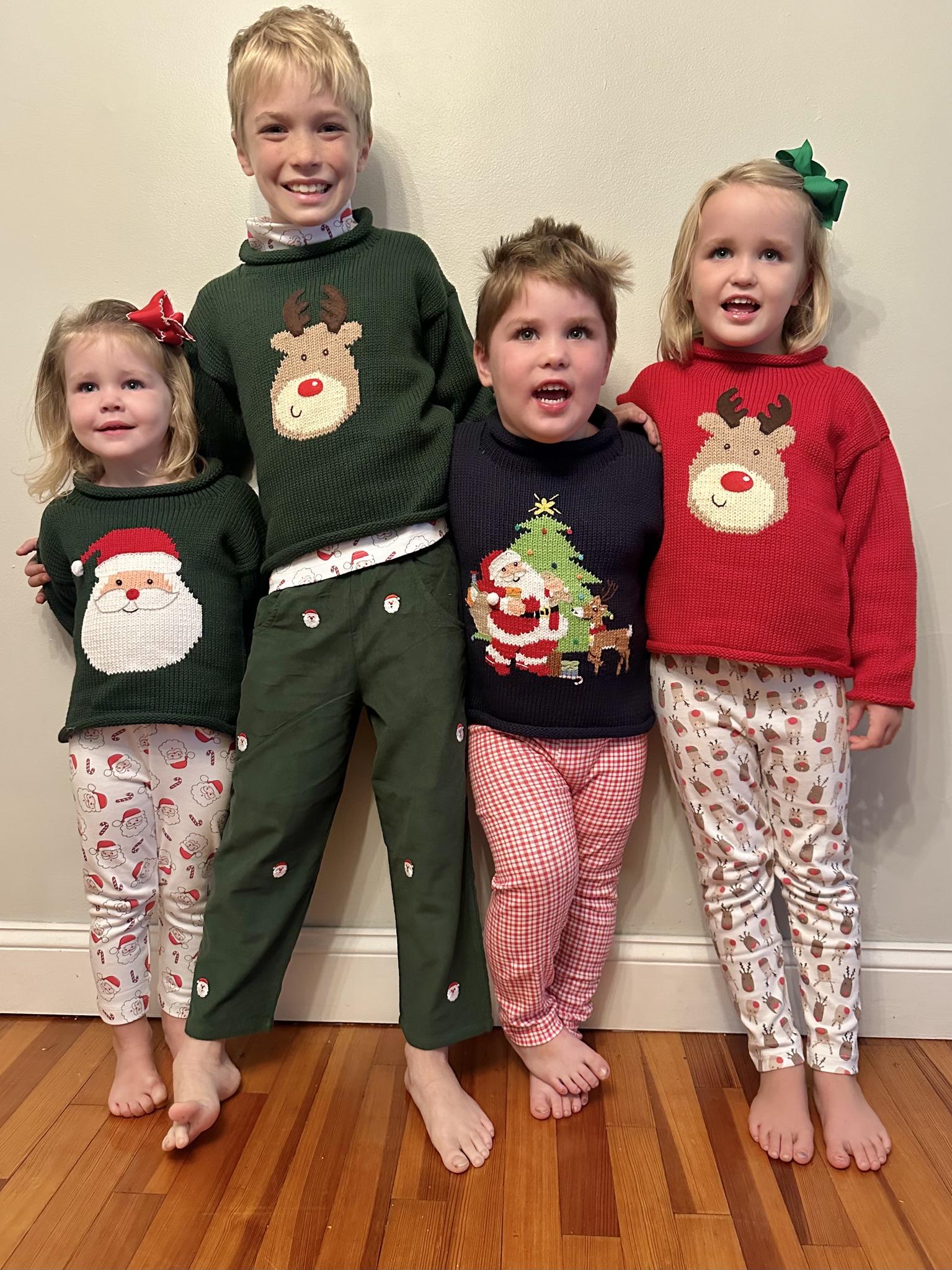 family of kids wearing christmas sweaters