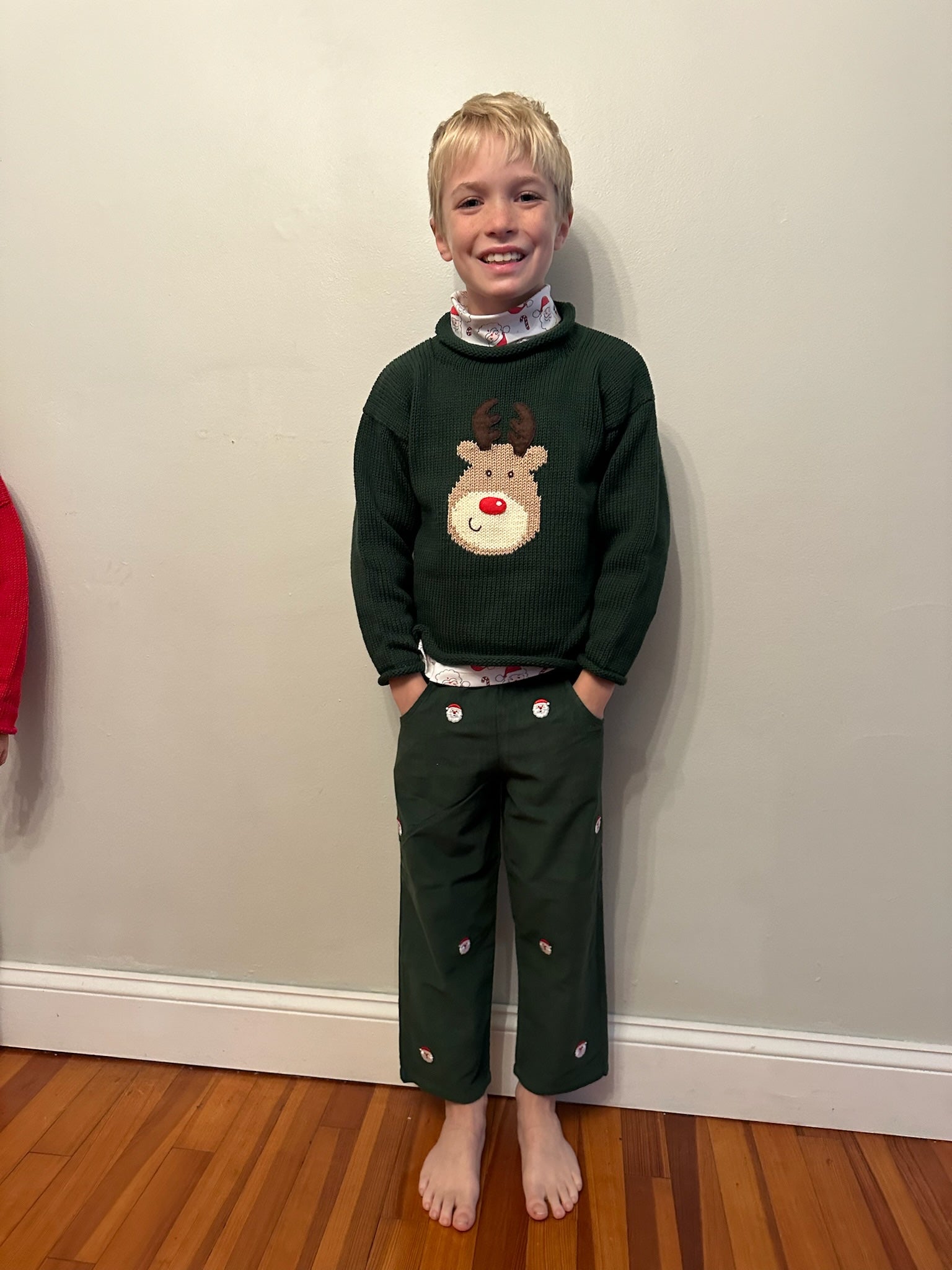 boy wearing rudolph sweater and rudolph pants
