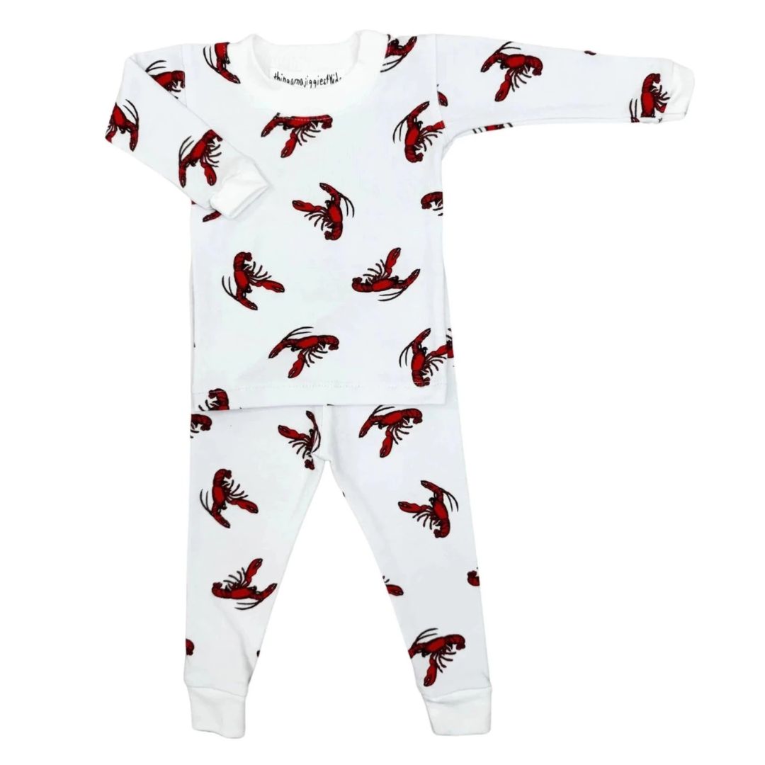 A baby long-sleeve pajama set featuring a white top and matching pants with an all-over red lobster print, laid flat on a white background.