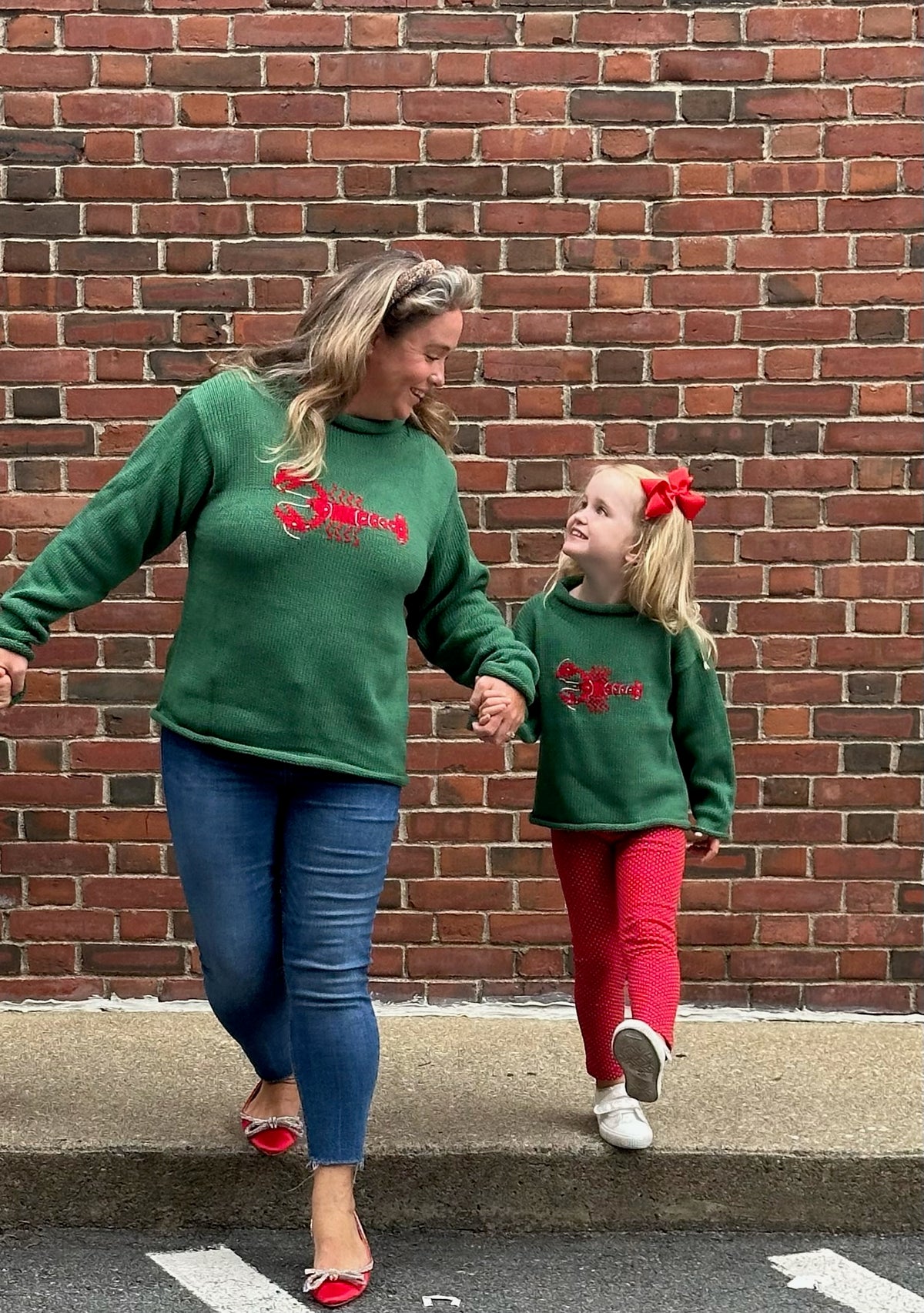 mom and daughter wearing matching christmas sweaters