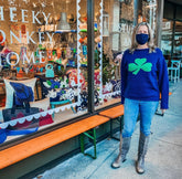 woman wearing navy shamrock sweater