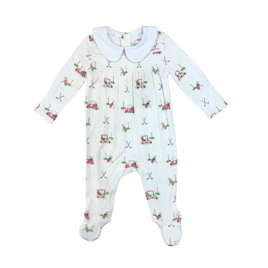 Baby onesie with golf cart pattern on a white background