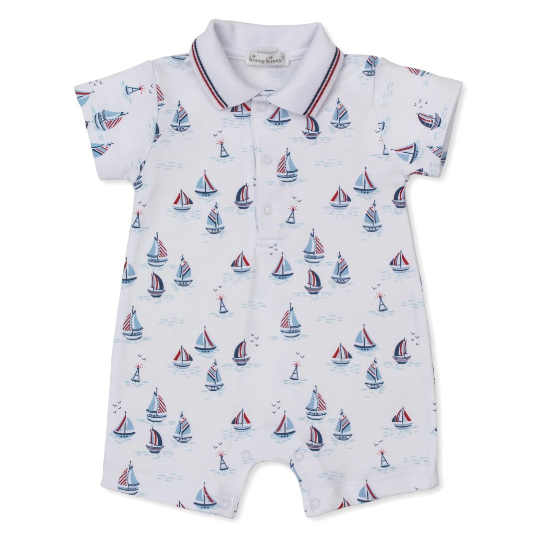 Baby romper with sailboat pattern on a white background