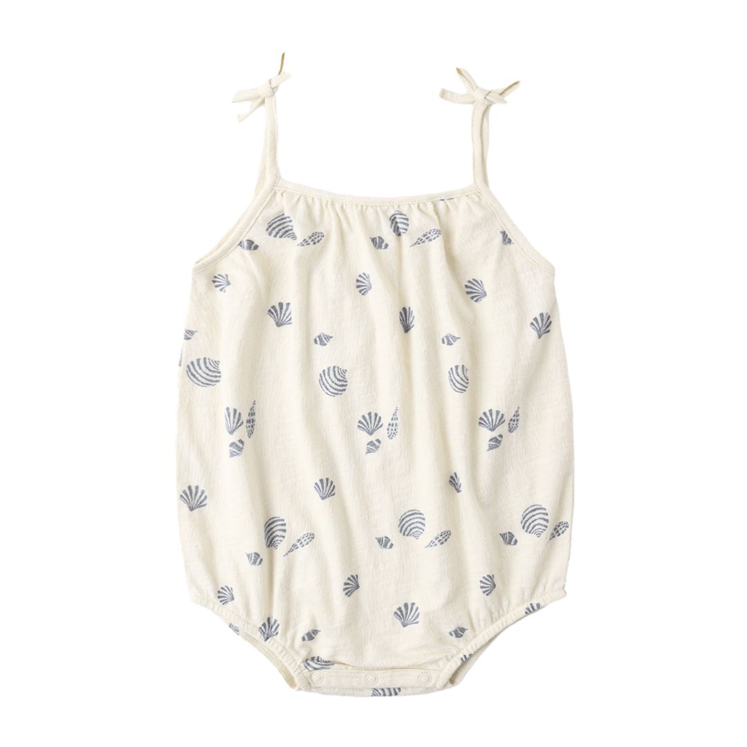 White baby romper with blue shell pattern on a white background