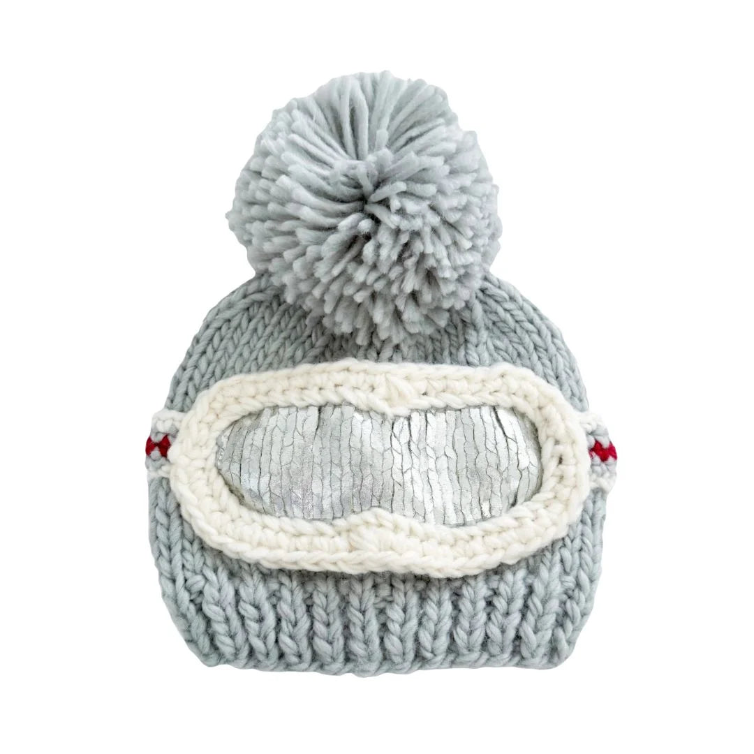 Gray knit beanie with a pom-pom and goggles on a white background