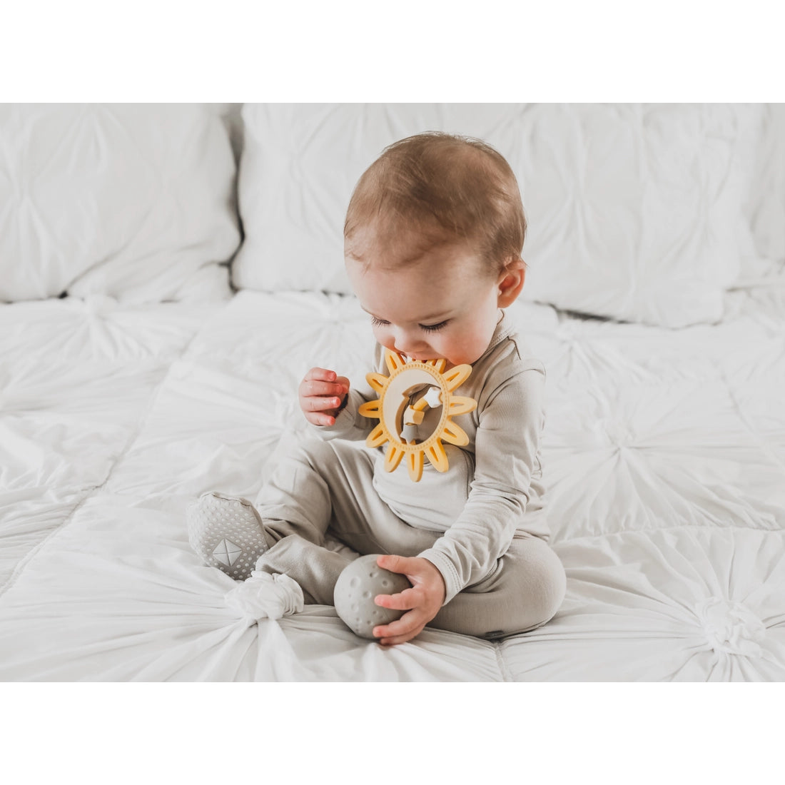 baby chewing on teether