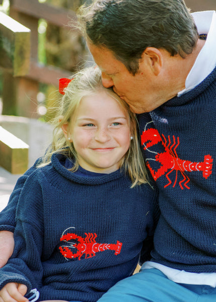 dad and daughter wearing matching navy lobster sweaters