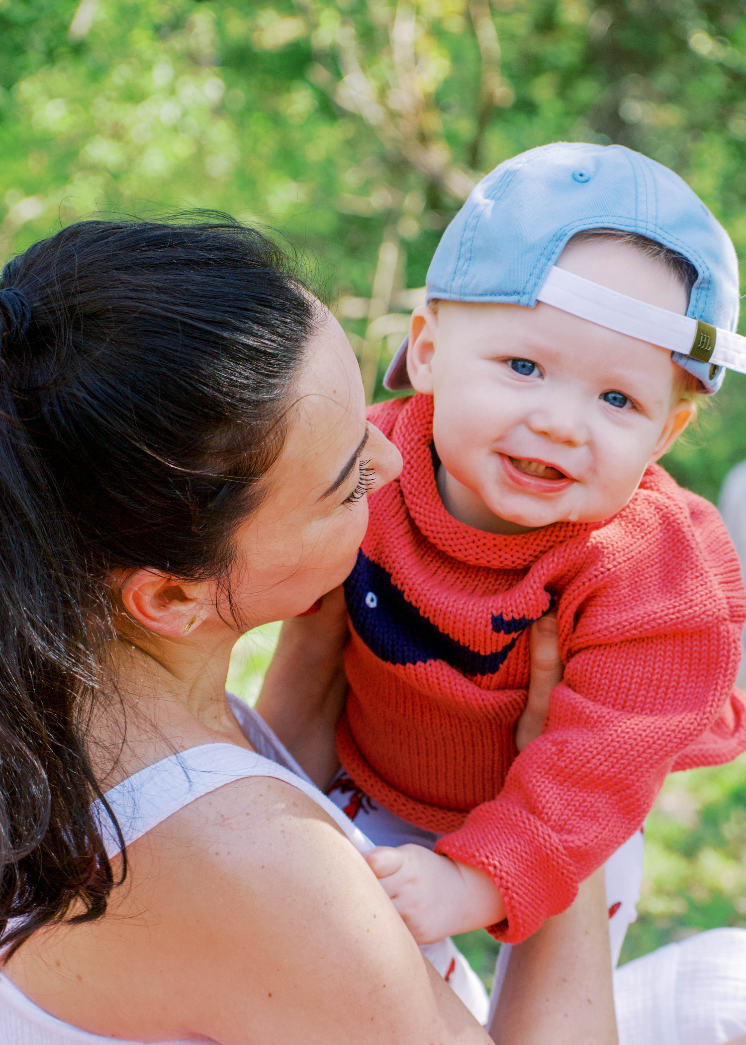 mom holding baby wearing sweater