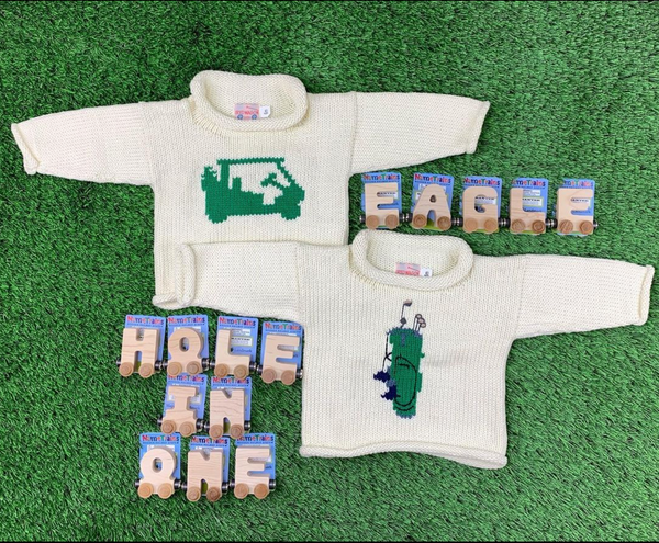 shows two golf sweaters with Eagle and Hole in One spelled out in name trains