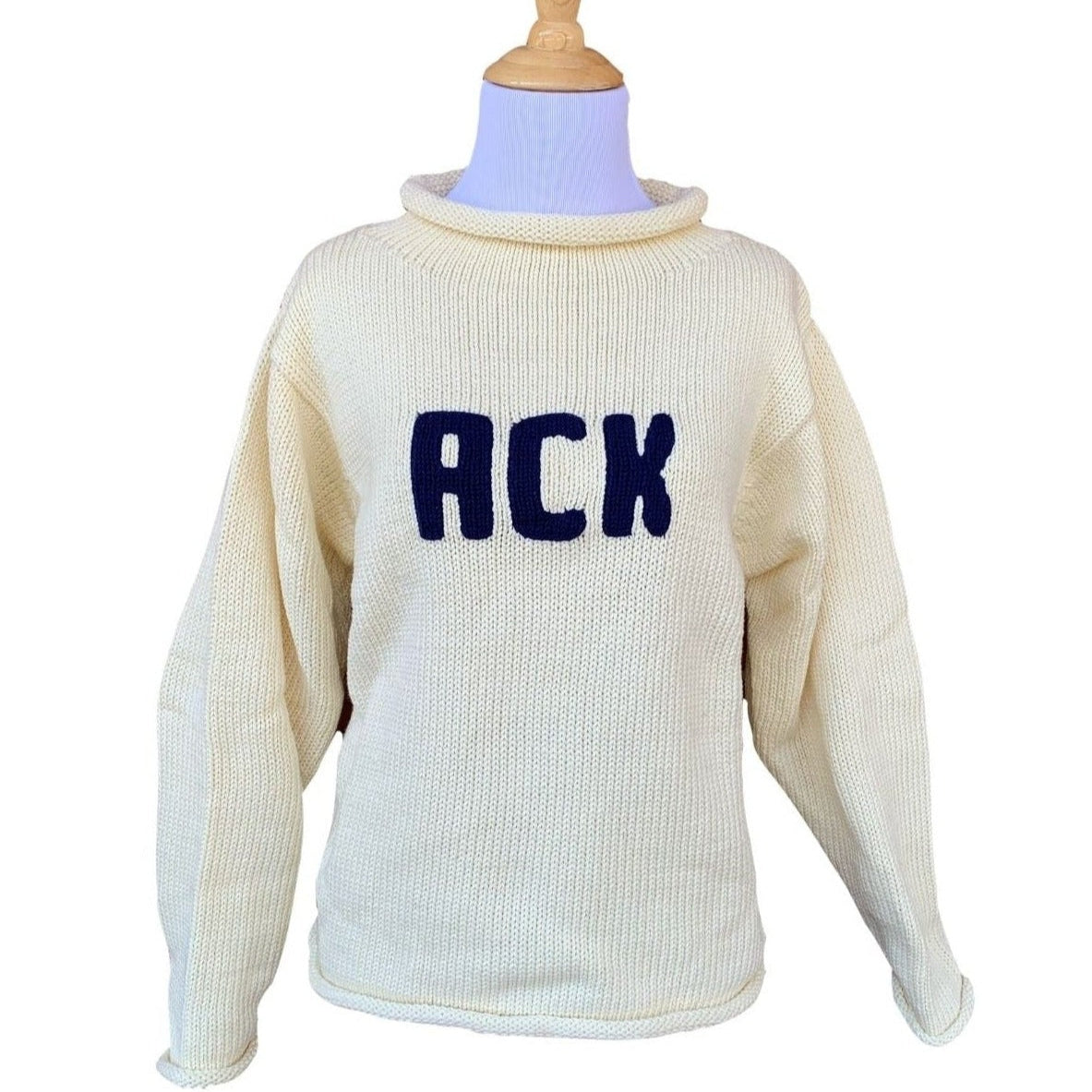 long sleeve ivory sweater with ACK written in navy