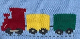 close up of train knitted design with red car at front, yellow car in middle and green car at end