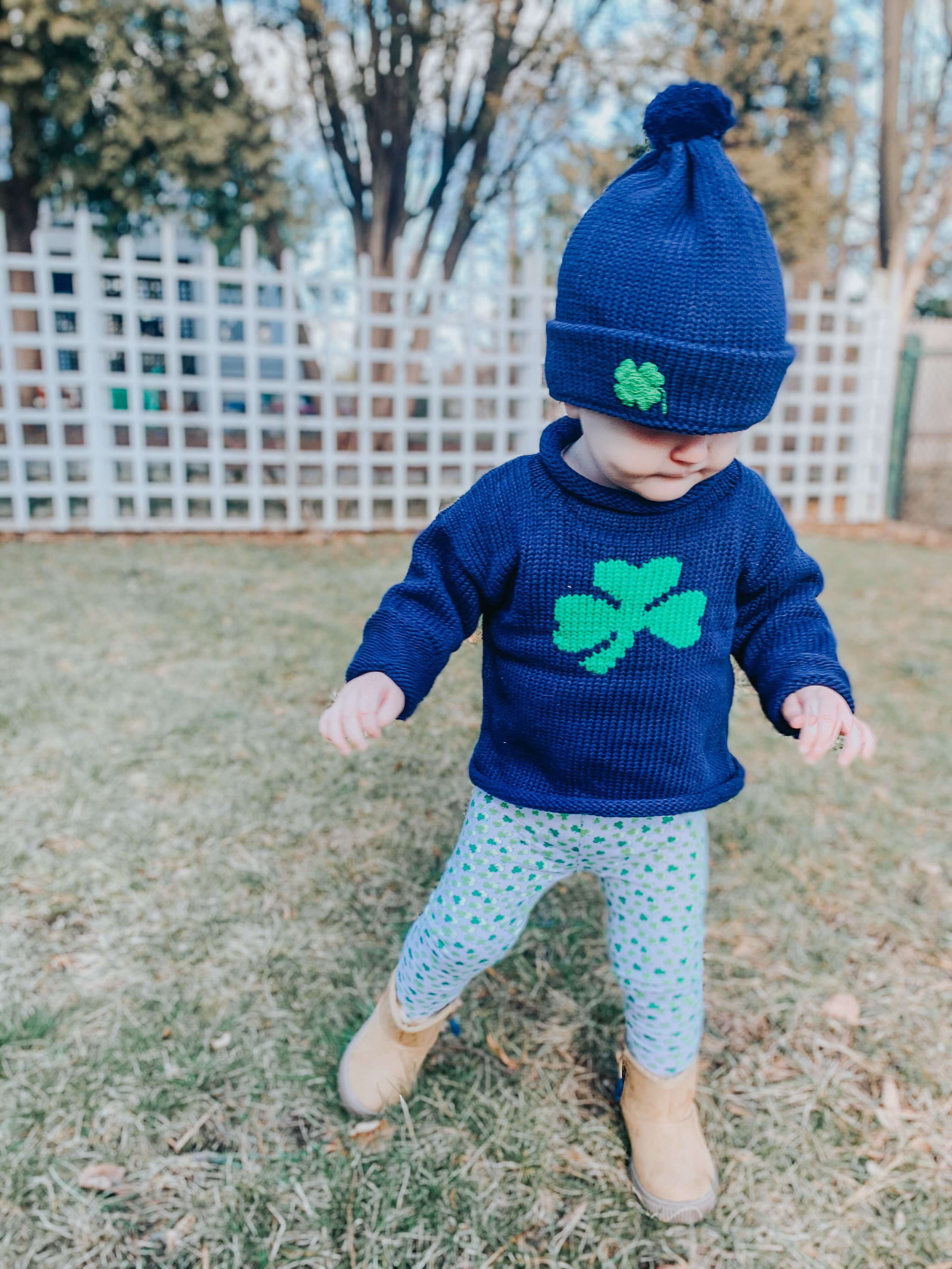 baby wearing Navy Shamrock Roll Neck Sweater and Navy Shamrock Hat with shamrock leggings and boots