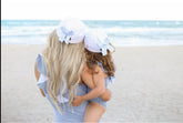 women and girl both wearing hats