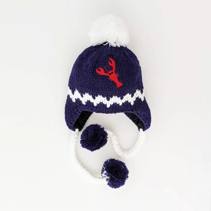 navy hat with red embroidered lobster and white pom