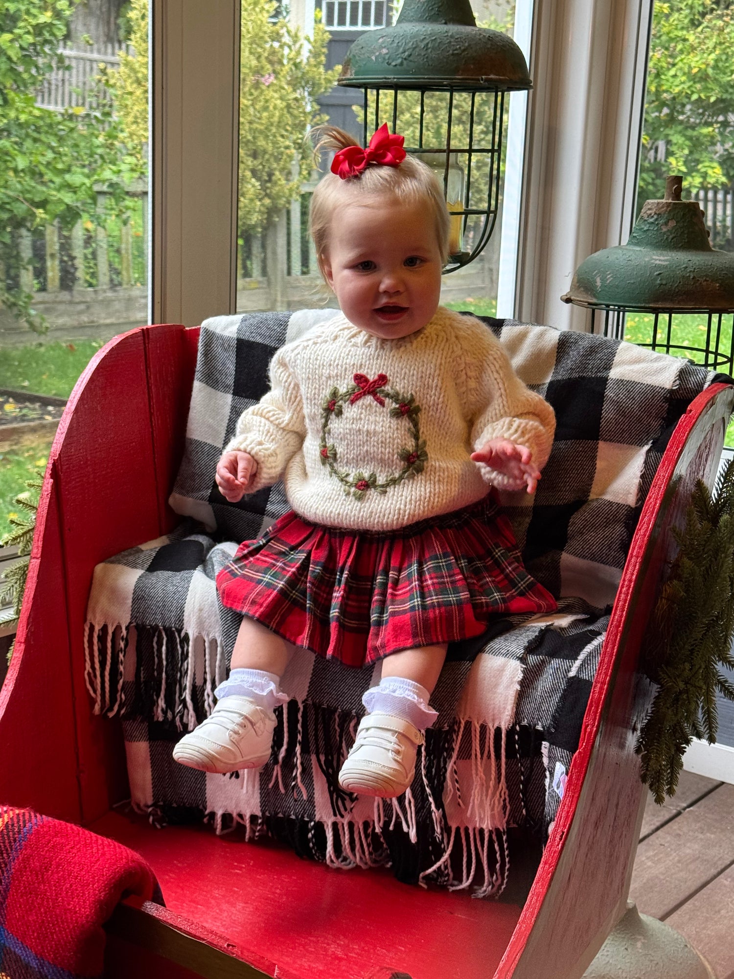 cream sweater with wreath on it