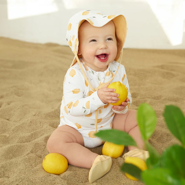 baby wearing lemon swimsuit