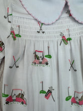 White dress with colorful golf-themed embroidery on a white background