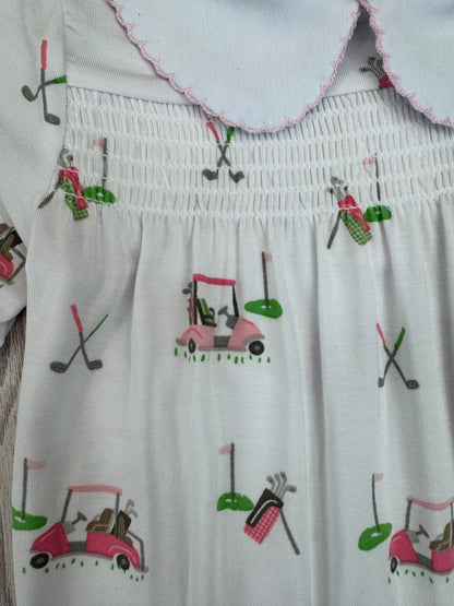 White dress with colorful golf-themed embroidery on a white background