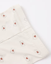 Folded fabric with heart and envelope patterns on a white background