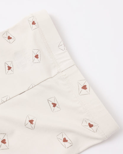 Folded fabric with heart and envelope patterns on a white background
