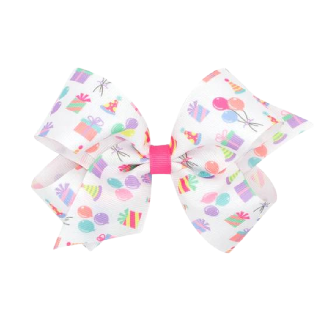 white bow with birthday decorations all over