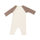 ivory romper with brown sleeves and brown bear face on chest