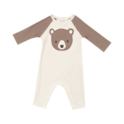 ivory romper with brown sleeves and brown bear face on chest