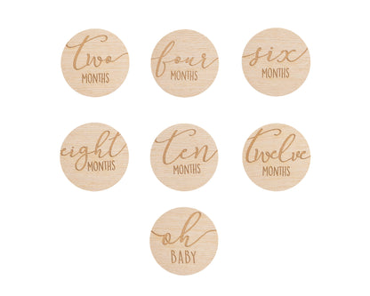 Set of wooden discs with milestone text for baby&