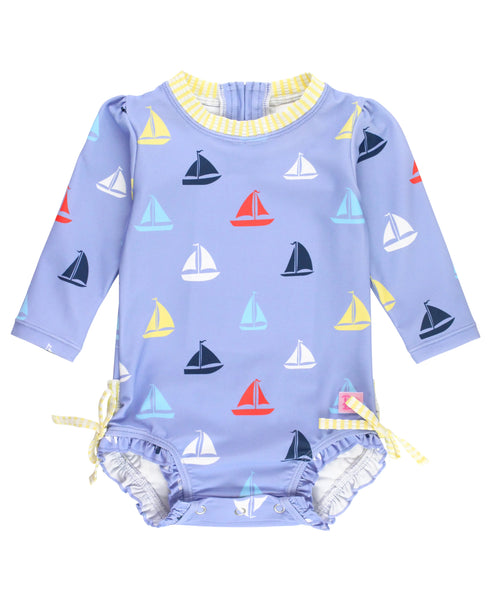 blue long sleeve rashguard suit with multi color sailboats all over and yellow seersucker trim
