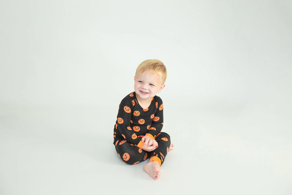 black 2 piece pajamas set with orange jack-o-lanterns