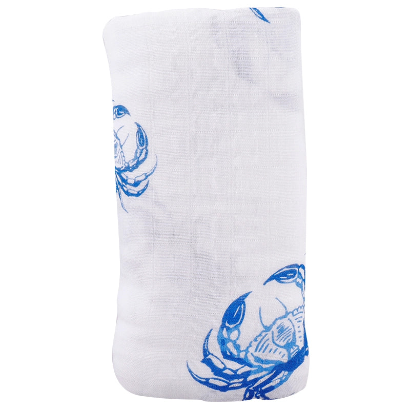 white baby swaddle with blue crab design