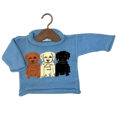 A light blue knit baby sweater with three cartoon labrador dog illustrations on the chest in brown, cream, and black, hanging on a wooden hanger against a white background.
