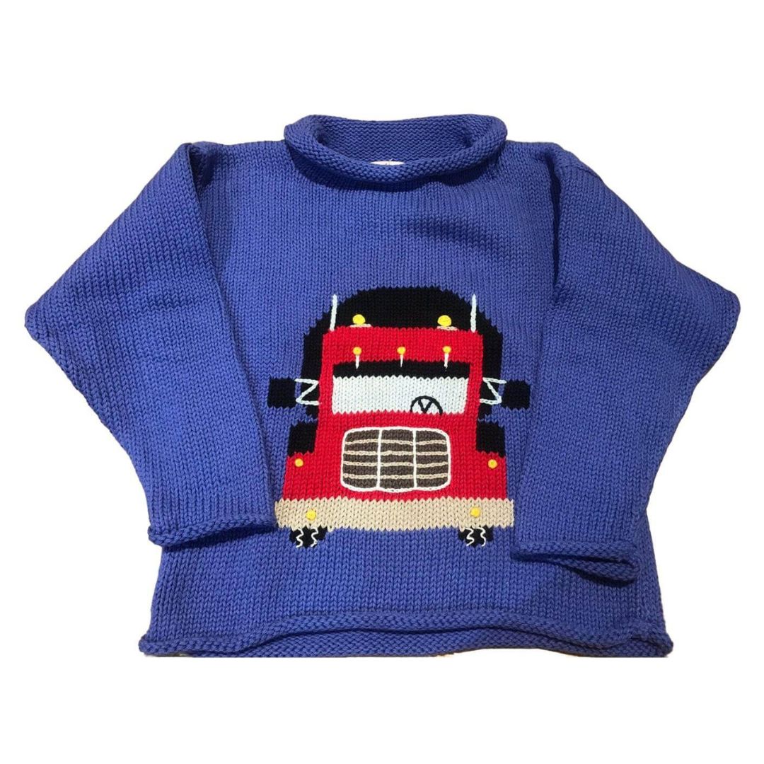 blue roll neck sweater with the front of a red and black tractor trailer knitted on front