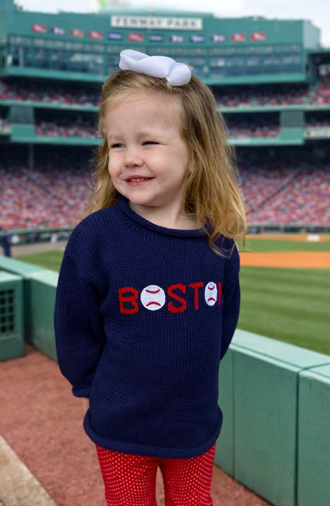 girl wearing boston sweater at Fenway park