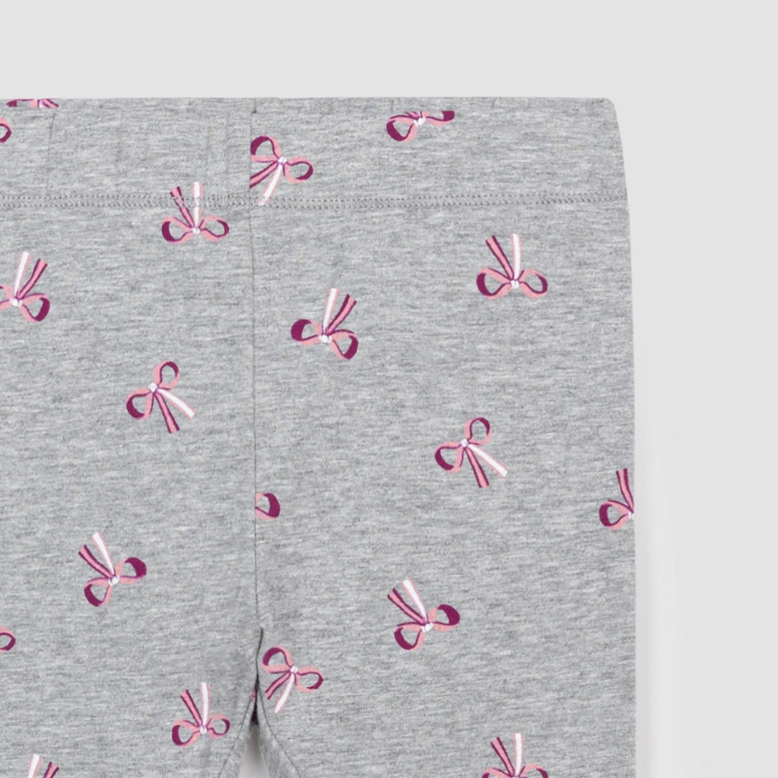 grey leggings with pink ribbon bows all over