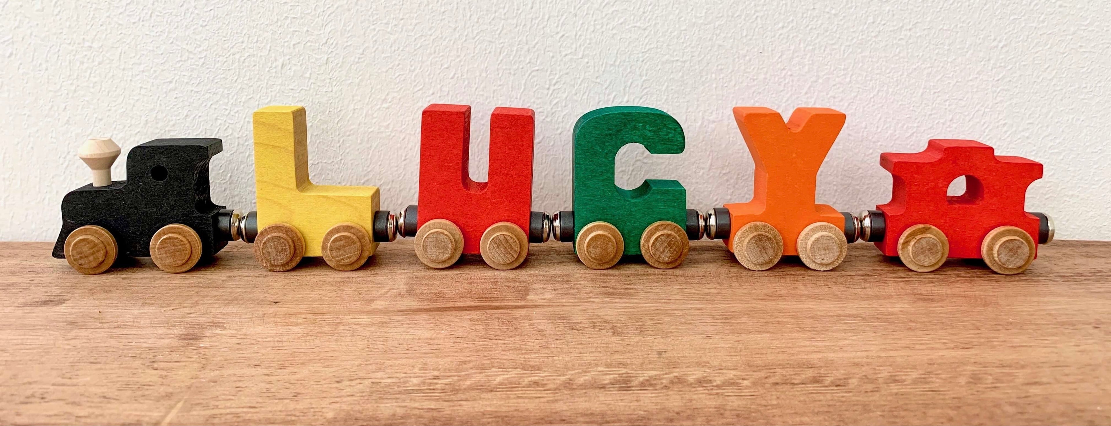 bright color wooden name trains spelling out the name Lucy