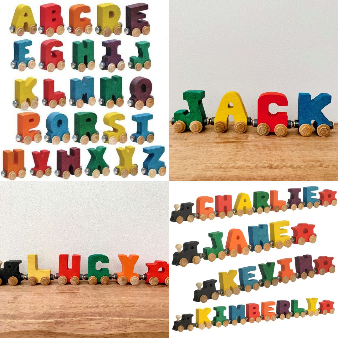 Colorful wooden letter trains on a wooden surface