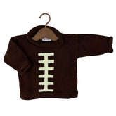 A dark brown knit kids sweater designed like a football, featuring a cream-colored lacing detail on the front, displayed on a wooden hanger against a white background.