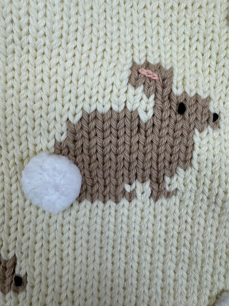 close up of knit bunny and pom pom tail