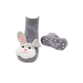 Gray bunny slipper socks with a white sole on a white background
