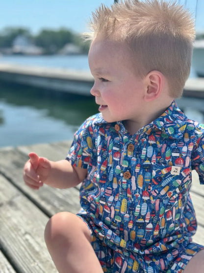 little boy on a dock wearing the buoy romper