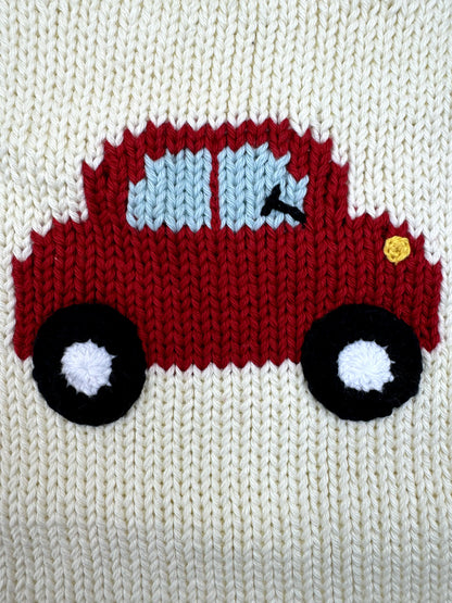 Knitted red truck with black wheels on a white background