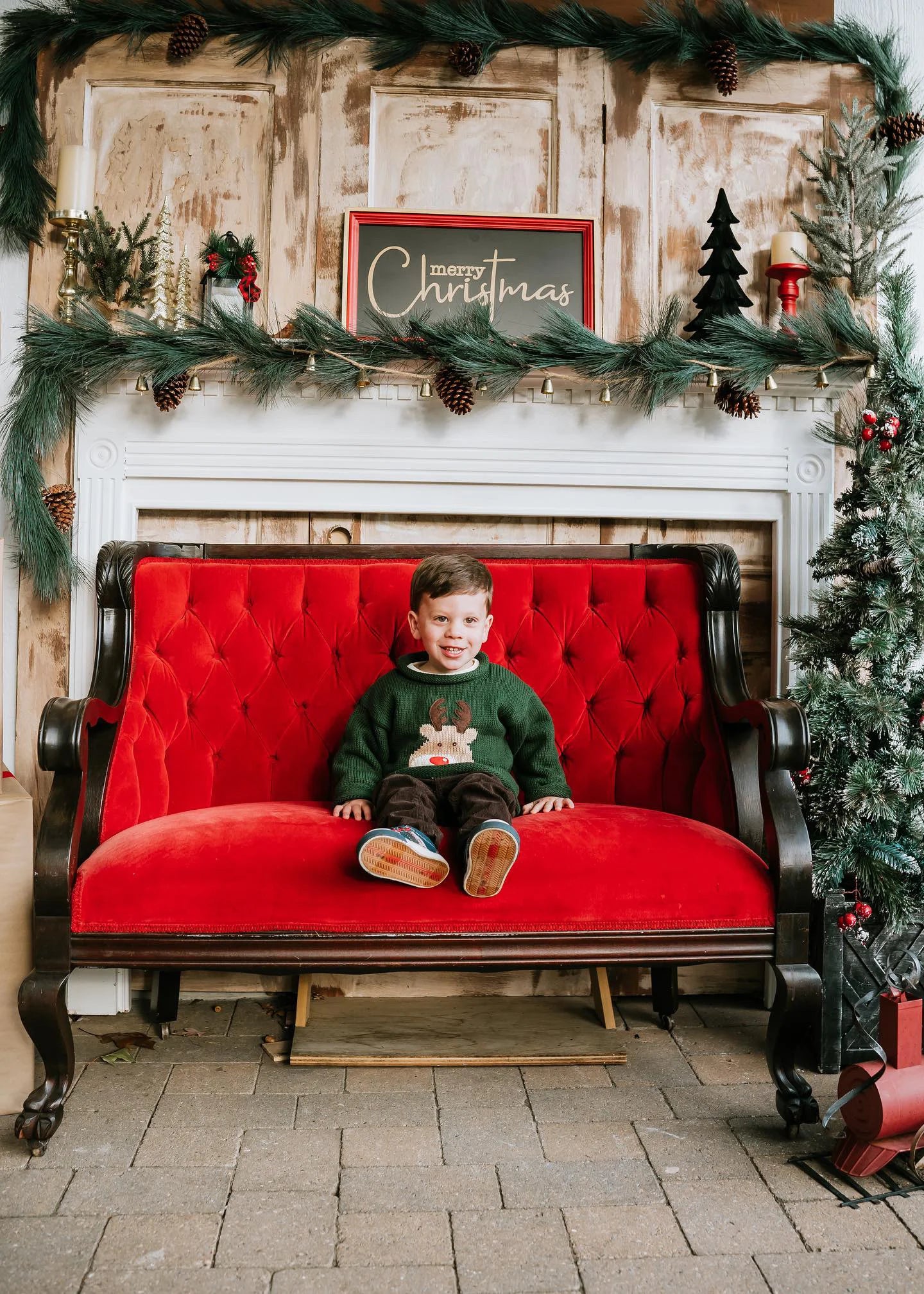 boy wearing green sweater with rudolph face