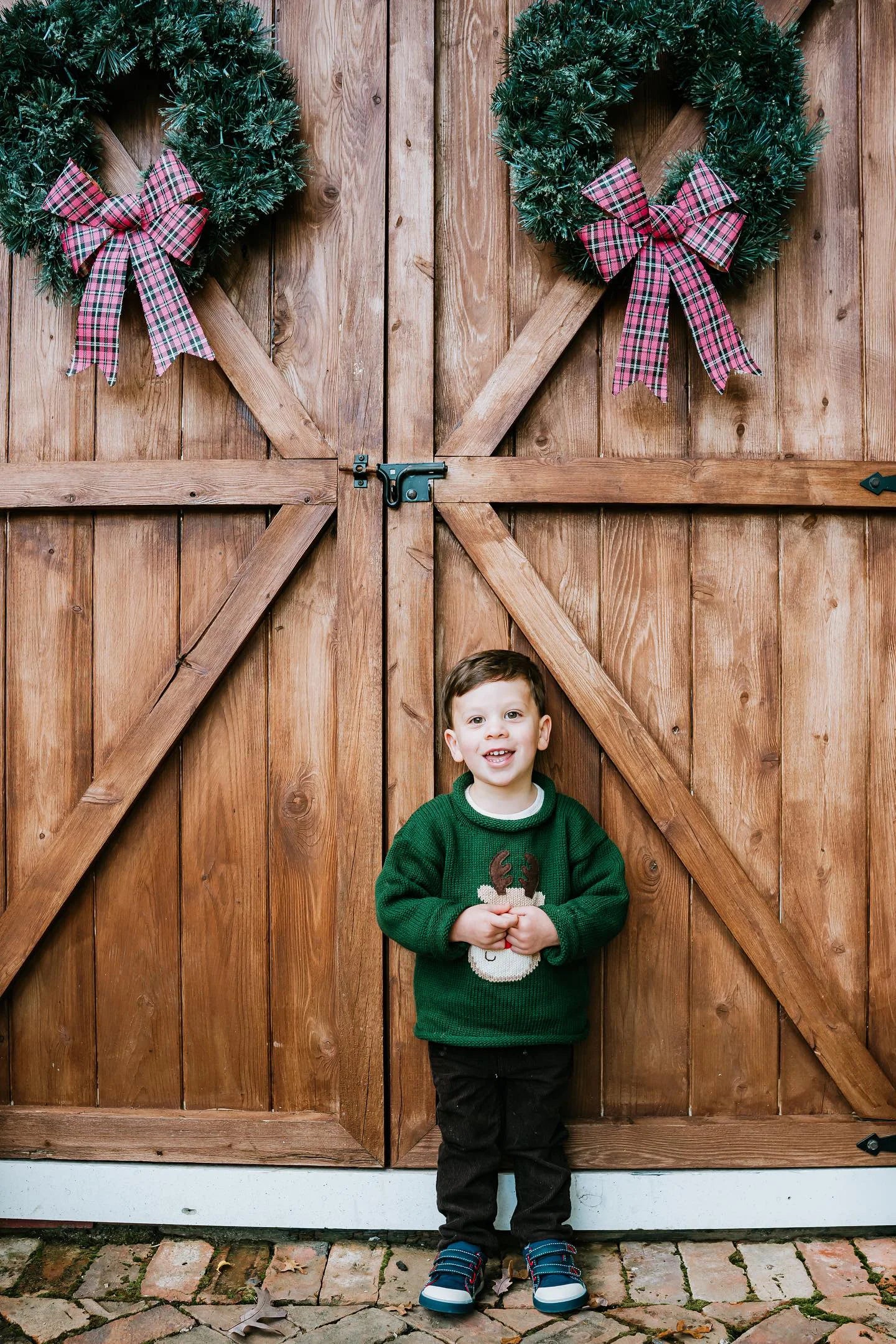 boy wearing green sweater with rudolph face